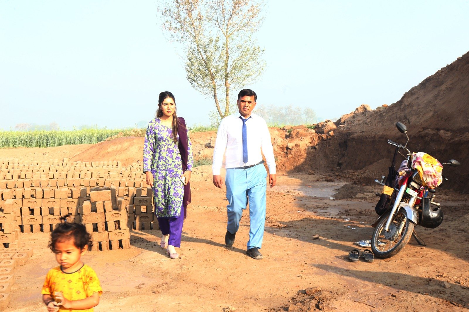 Mahnoor and Pastor Shahid Naveed walking together at the brick kiln