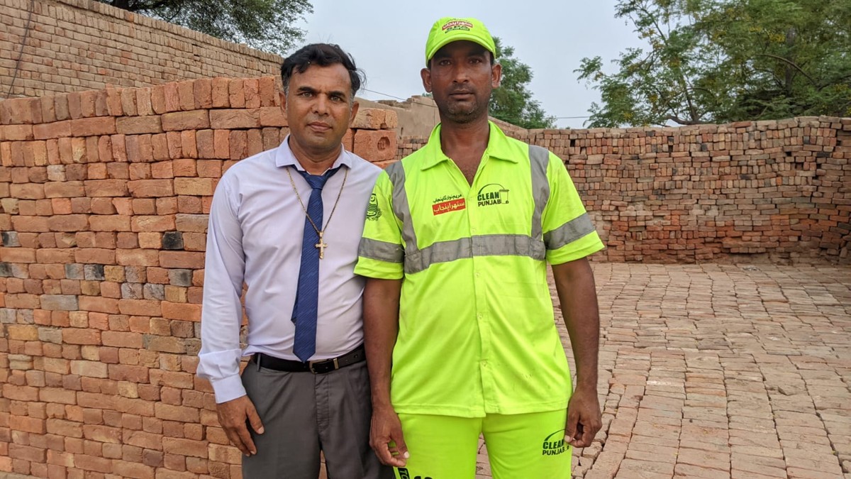 Pastor Shahid Naveed with Yasir Masih at his sanitation job