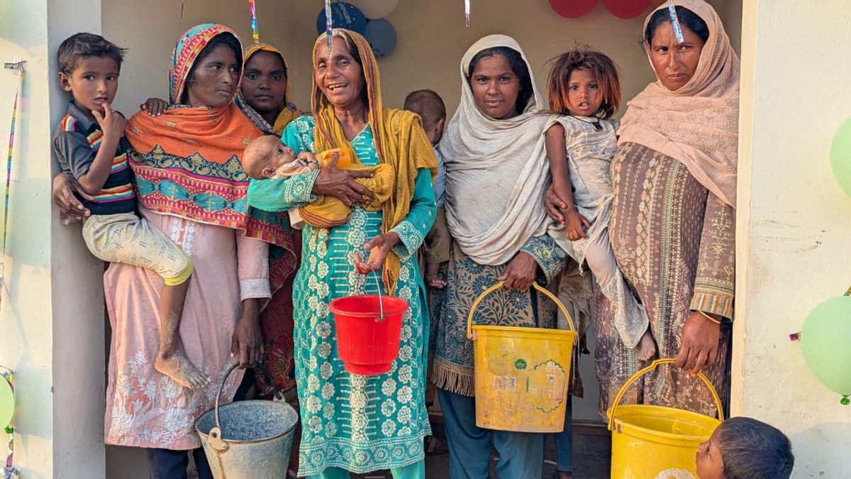 Women and children with buckets at the new water station